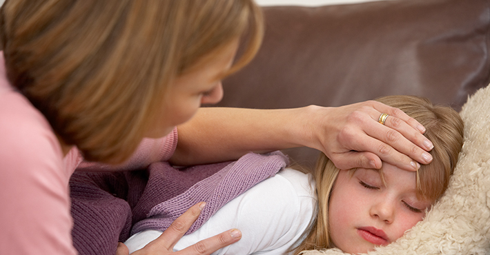 Mother Taking Temperature Of Sick Daughter